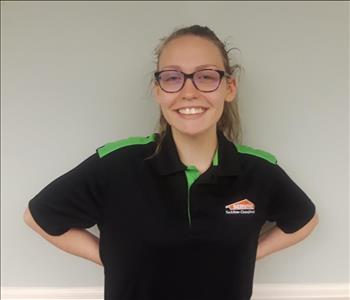 Young woman wearing a SERVPRO uniform and glasses