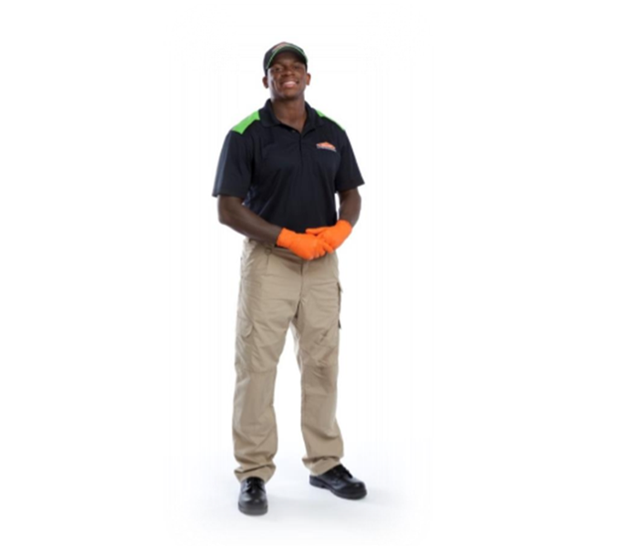 young man wearing a SERVPRO uniform and gloves